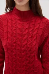 Polera de tejido de punto color crema, con cuello alto y diseño de trenzas verticales. Presenta mangas largas con puños acanalados y un corte holgado.