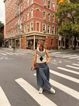 Falda larga negra con diseño de caderín y tablas.