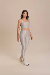 Top deportivo gris con tecnología adaptable Lycra Adaptiv, breteles finos cruzados en la espalda y copas removibles.
