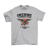 Remera de algodón gris con estampa frontal de la banda Creedence Clearwater Revival, presentando un águila con diseño estilo tatuaje tradicional y un sol rojo de fondo.