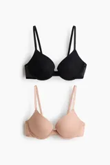 Pack de dos soutienes push-up de microfibra, uno en color negro y otro en color beige, con copas con relleno y detalles de malla en los laterales.
