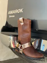 Bota de cuero marrón con estribo desmontable plateado.