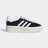 Championes Adidas Gazelle Bold negros con plataforma color crema, con las tres tiras blancas clásicas de la marca y detalle dorado con el nombre del modelo.