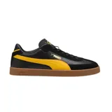 Championes urbanos Puma modelo Club Li Era, color negro con detalles en amarillo y suela de goma color caramelo. Presentan el logo de la marca en el lateral y la lengüeta.