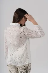 Camisa blanca de algodón con bordados perforados y botones de madera.