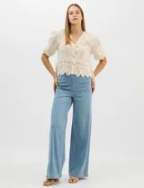 Jegging de denim azul oscuro con silueta estilo palazzo, tiro alto y pierna amplia, con pretina ancha elástica y sin bolsillos frontales.