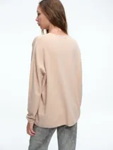 Cardigan de calce relajado confeccionado en tejido de viscosa con micro lentejuelas. Presenta diseño abierto al frente con cierre de broche, mangas largas y silueta recta.