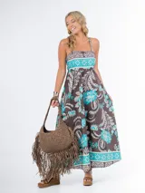 Vestido largo de algodón italiano con estampado floral en tonos azul, amarillo y blanco. Tiene escote cuadrado, corte imperio y elástico en la espalda.