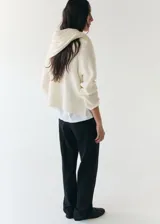 Chaleco largo de punto color blanco marfil, con diseño abierto y superpuesto de estilo versátil.