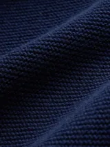 Buzo de punto de algodón con cuello redondo, mangas tipo raglán y puños y ruedo acanalados.