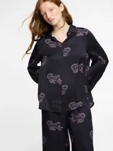 Pantalón palazzo negro con estampado de tigres rosas, cintura elástica y bolsillos laterales.