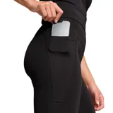 Calza larga de tiro alto color negro, con corte acampanado y logo Puma estampado en blanco en la pierna izquierda.