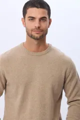 Buzo tejido de lana con cuello redondo a la base y mangas largas. Presenta un diseño clásico y minimalista con un pequeño logo bordado en el pecho.