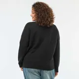 Sweater negro de punto con cuello cruzado tipo solapa, manga larga y detalle de strass de fantasía aplicado en toda la prenda.