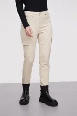 Pantalon tipo cargo de jean en color natural, con bolsillos laterales con solapa y cierre frontal con botón y cremallera.