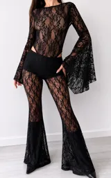 Body de encaje negro con diseño floral, cuello redondo y mangas largas acampanadas con terminación amplia.