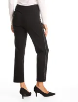 Pantalón slim fit de tiro alto con pretina ancha elastizada y detalle de hilera vertical de micro-tachas metálicas en los laterales. Diseño al tobillo con ruedo recto.