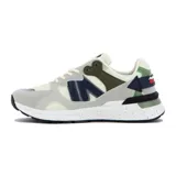 Championes de estilo running/lifestyle de la marca Austral, modelo Ushuaia Teen. Presentan una combinación de colores: base en blanco hueso/crema, superposiciones en gris claro, detalles en azul marino, verde oliva y un toque de azul oscuro en el talón. La mediasuela es blanca con salpicaduras negras y el logo de Austral 1997 es visible en el lateral del talón.