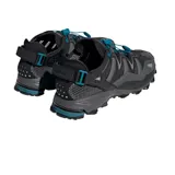 Championes de trail running Adidas Hyperturf Adventure, color negro con detalles en gris y acentos en azul petróleo. Presentan un diseño robusto con malla técnica, refuerzos sintéticos, sistema de ajuste rápido con cordón elástico y suela con tecnología Adiprene+ para mayor amortiguación.