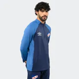 Buzo de entrenamiento Umbro del Club Nacional de Football, con medio cierre frontal, mangas largas y diseño en bloques de color azul y azul marino. Cuenta con el logo de la marca y el escudo del club en el pecho.
