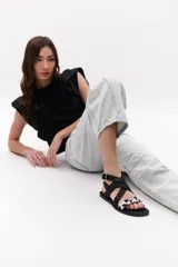 Sandalias negras con tiras cruzadas de cuero y pelo vacuno con estampado animal print.