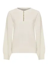 Sweater de punto color beige claro, con escote redondo y cierre frontal parcial de botones con reborde metalizado, mangas largas abullonadas y puños y ruedo elásticos.