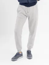 Pantalón de jogging azul marino, confeccionado en felpa, con cintura elástica ajustable con cordón y puños acanalados en los tobillos.