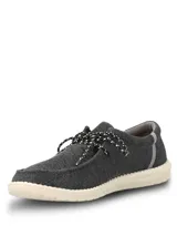 Alpargata Hush Puppies modelo Canyon, color negro con textura tejida. Presenta cordones jaspeados en blanco y negro, y suela de EVA en color crema.