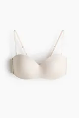 Soutien strapless de microfibra en color beige con copas acolchadas, tirantes ajustables y desmontables, y cierre posterior de corchetes.
