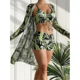 Conjunto de traje de baño de tres piezas con estampado de hojas tropicales en tonos blanco y negro. Incluye un top tipo tankini con cordón ajustable en el centro, un short de tiro alto y una camisa abierta de manga larga tipo salida de baño.