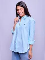 Camisa de manga larga a rayas verticales celestes y blancas, de corte suelto, confeccionada en algodón.