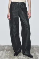 Jeans de tiro bajo con corte barrel leg y largo completo. Presentan un acabado craquelado, diseño de cinco bolsillos, trabillas en la cintura y cierre frontal con cremallera y botón metálico.