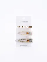 Set de tres pinzas para el pelo: una dorada con perlas, una transparente con detalles iridiscentes y una plateada con glitter.