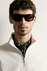 Sudadera negra de corte regular fit, con cuello subido, cierre frontal de cremallera corta y acabados en rib elástico en puños y cintura.