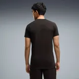 Remera deportiva Puma de manga corta color negro, con el logo de la marca en amarillo en el pecho y el escudo del Club Atlético Peñarol.