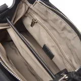 Cartera tipo bolso de mano color negro, confeccionada en material textil. Cuenta con doble asa superior, correa ajustable extraíble, detalle de dije colgante con cordones en tonos verde lima y negro, y logo circular grabado en el frente.