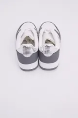 Zapatillas de diseño urbano en color blanco con inserciones en gris oscuro, cordones al tono y detalle de estrella bordada en el lateral.