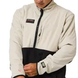 Buzo de polar con diseño bicolor, parte superior en color beige y parte inferior en negro. Presenta cierre frontal de media cremallera, cuello alto, bolsillo en el pecho con cierre y bolsillos laterales. Incluye parches decorativos en el pecho y en la manga.