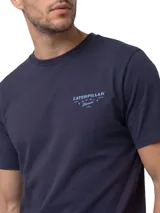 Remera Caterpillar de color azul marino, de manga corta y cuello redondo. Cuenta con un pequeño gráfico bordado en el pecho y un parche de la marca en el borde inferior.