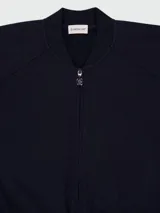 Chaqueta tipo bomber de Moncler, color azul marino, con cierre frontal de cremallera, cuello redondo y puños elásticos.