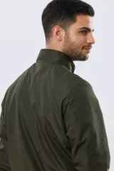 Campera liviana de nylon color azul marino, con cuello alto, cierre frontal y puños y dobladillo en elástico tejido.