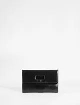 Sobre plegable de cuero vegano con diseño minimalista y abertura superior integrada. Incluye correa removible para usar como bandolera.