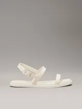 Sandalias Calvin Klein de goma color crema, con tira delantera y tira trasera ajustable con hebilla.