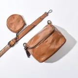 Bandolera marrón con correa ajustable y monedero redondo extraíble.