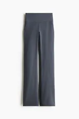 Leggings de yoga acampanadas en tejido funcional color gris, de tiro alto con cintura ancha.