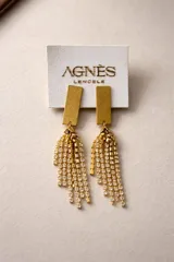 Aros colgantes de diseño geométrico con base rectangular dorada y flecos de cadenas con cristales brillantes.