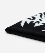 Gorro tipo beanie reversible de punto, con diseño tribal abstracto en contraste blanco y negro. Confeccionado en tejido de acrílico suave, ofrece aislamiento térmico y un ajuste cómodo.