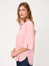 Camisa de manga corta celeste, confeccionada en mezcla de algodón y lino, con cuello camisero y cierre frontal de botones.
