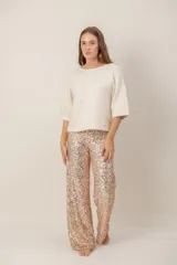 Pantalón de corte recto y tiro alto, completamente cubierto de lentejuelas en tono rosado metalizado.