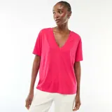 Camiseta de manga corta en color rosa vibrante, con escote en pico y corte estándar.